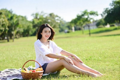 Asian woman with fruit basket on picnic