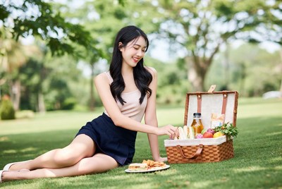 Asian woman picnic basket grass