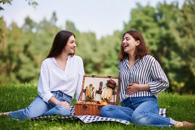Two women enjoying picnic in park