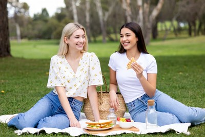 Two women eating picnic in park