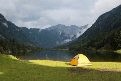 Yellow tent by mountain lake