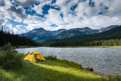 Yellow tent by mountain lake