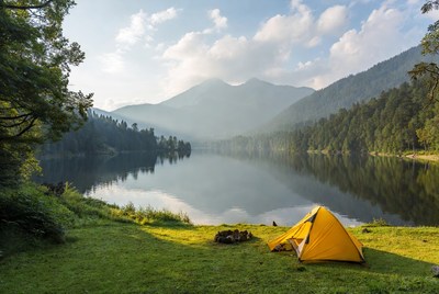 Yellow tent by mountain lake