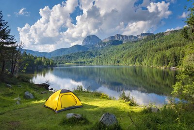 Yellow tent by mountain lake