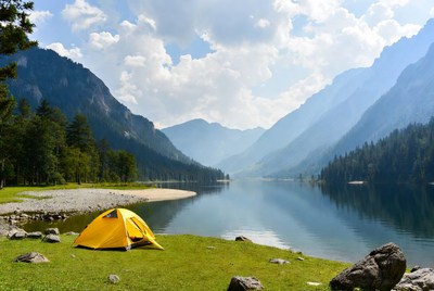 Yellow tent by mountain lake