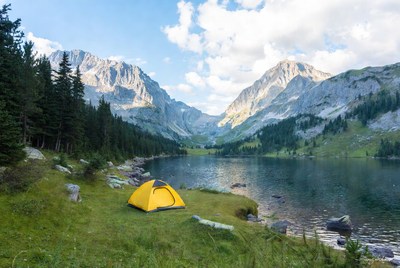 Yellow tent by mountain lake