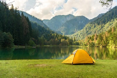 Yellow tent by mountain lake