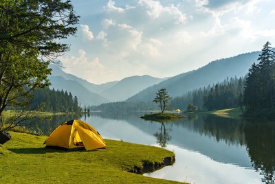 Yellow tent by mountain lake