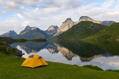 Yellow tent by mountain lake
