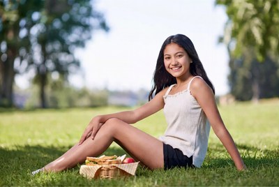Asian girl with picnic basket in park