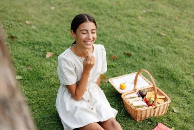 Woman with picnic basket on grass