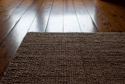 Brown rug on wooden floor