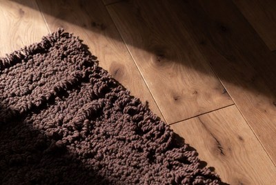 Brown shag rug on hardwood floor