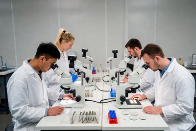 Students using microscopes in lab