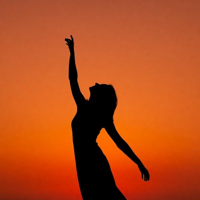 Woman dancing silhouette at sunset