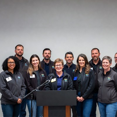 Team speaking at podium with microphones