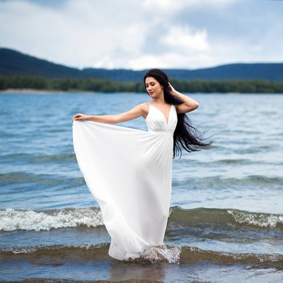 Woman in white dress at lakeshore