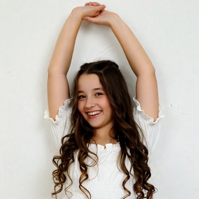 Girl raising arms smiling white background