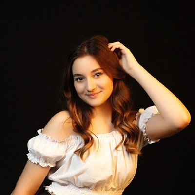 Smiling woman with hand on head