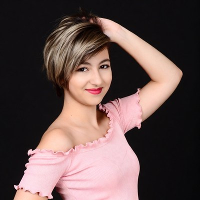 Woman with short hair hand on head