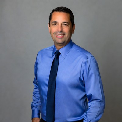 Smiling man in blue shirt and tie
