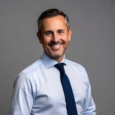 Smiling man in blue shirt and tie
