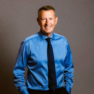 Smiling man in blue shirt and tie