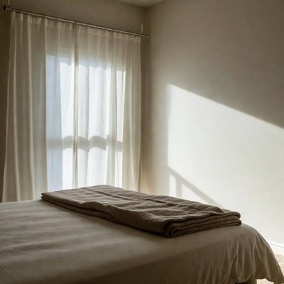 Bedroom with white curtains and bed