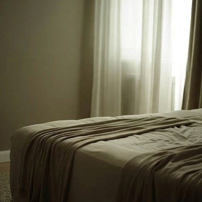 Empty Bed with Sheer Curtains