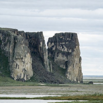 Towering Cliffs Over Marshland
