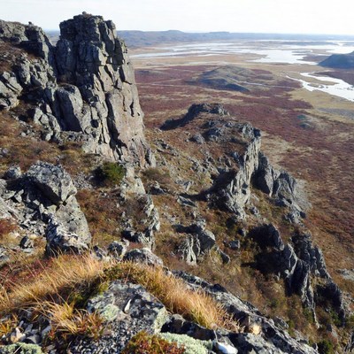 Rocky Cliff Over Autumn Tundra Landscape