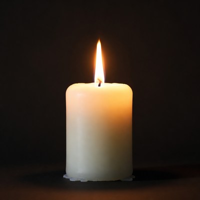 Burning Candle on Black Background