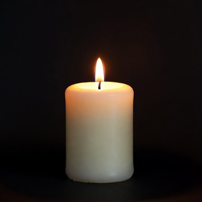 Burning Candle on Black Background