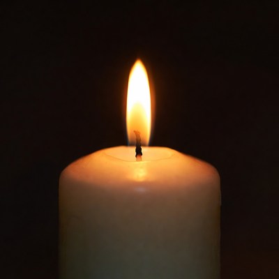 Burning Candle Flame on Black Background