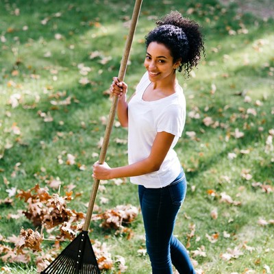 African-American woman raking leaves