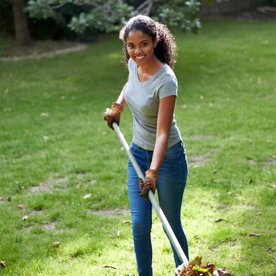 African-American girl raking leaves