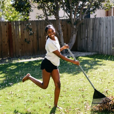 African-American girl raking leaves