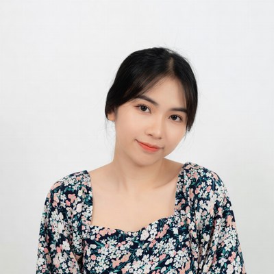 Asian woman in floral blouse smiling