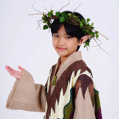 Boy in elf costume with ivy crown
