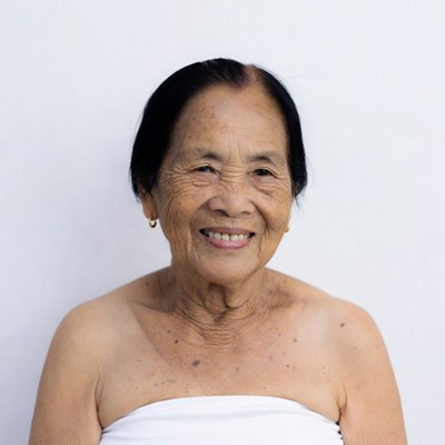 Elderly Asian woman smiling topless
