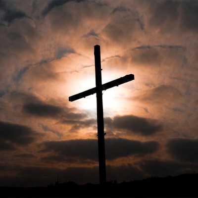 Silhouette cross sunset clouds