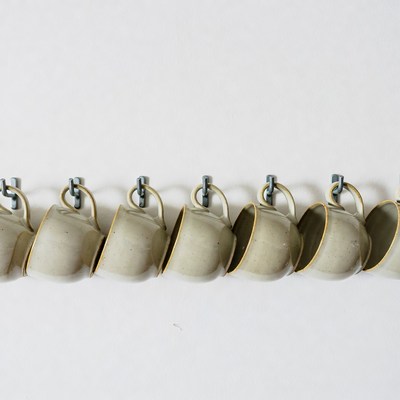 Beige Mugs Hanging on Wall