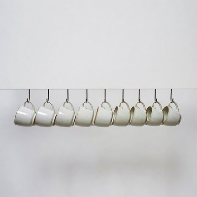 White Mugs Hanging on Hooks