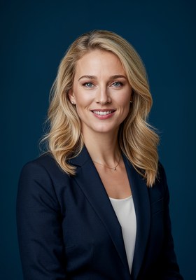 Blonde woman in navy suit smiling