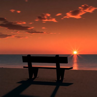 Empty bench facing sunset beach