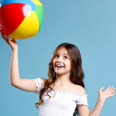 Girl holding colorful beach ball