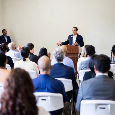 Man speaking at podium to audience