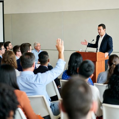 Man speaking at business conference podium