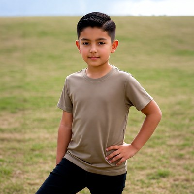 Young Latino boy posing in grass field