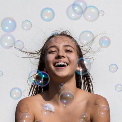 Nude girl smiling with bubbles